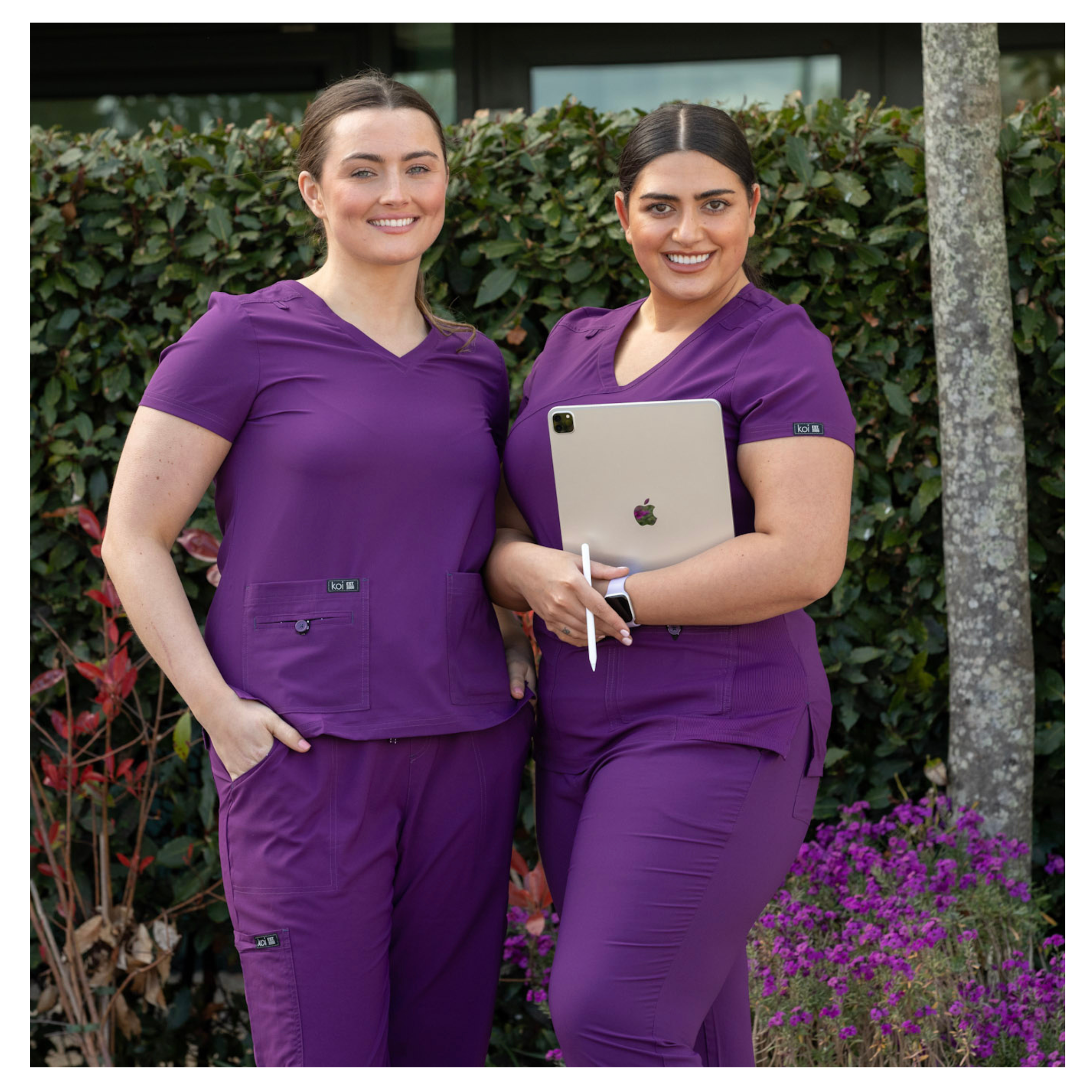 Care home assistants in happythreads uniforms in eggplant colour