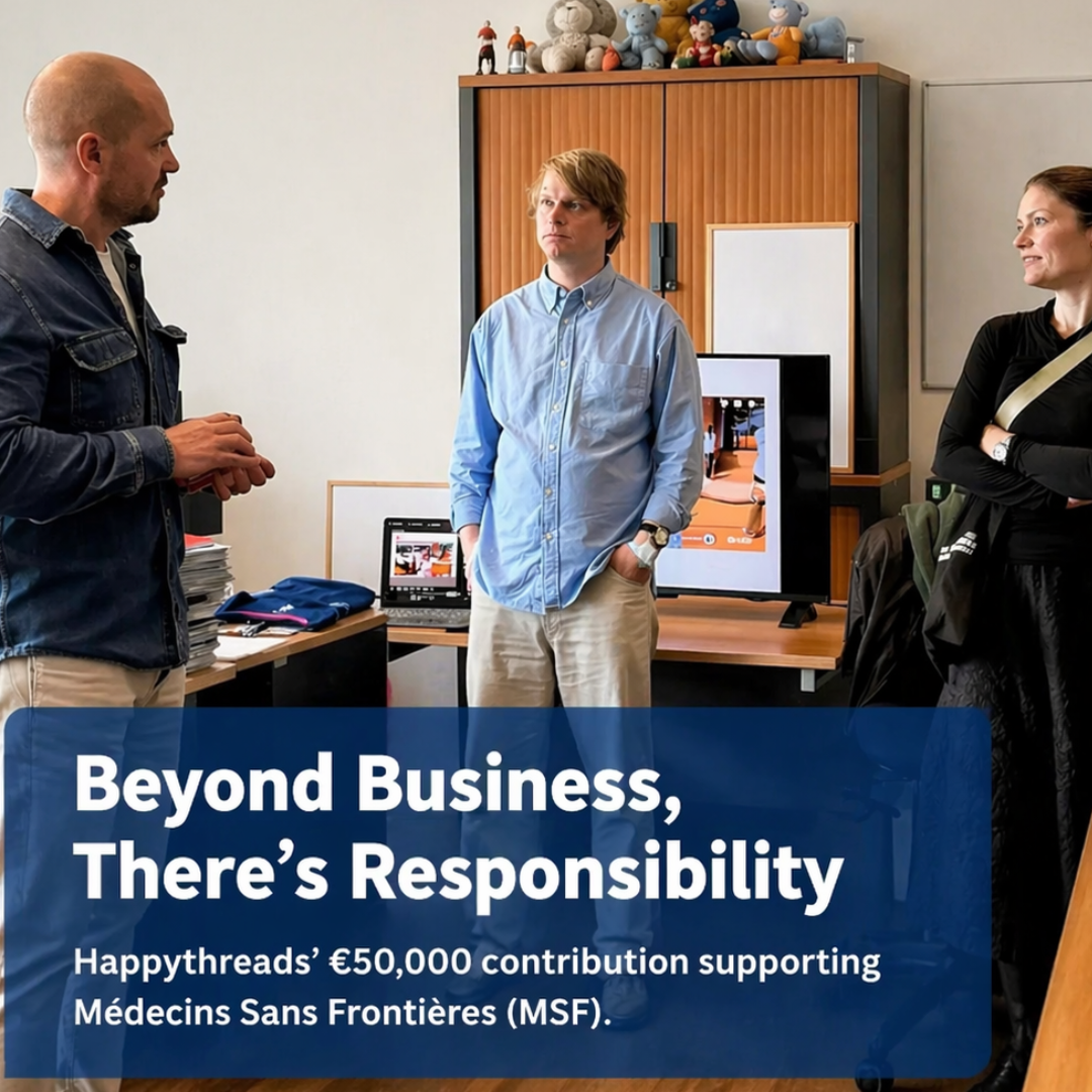 Happythreads team presenting €50,000 contribution to Médecins Sans Frontières during office meeting in a modern workspace