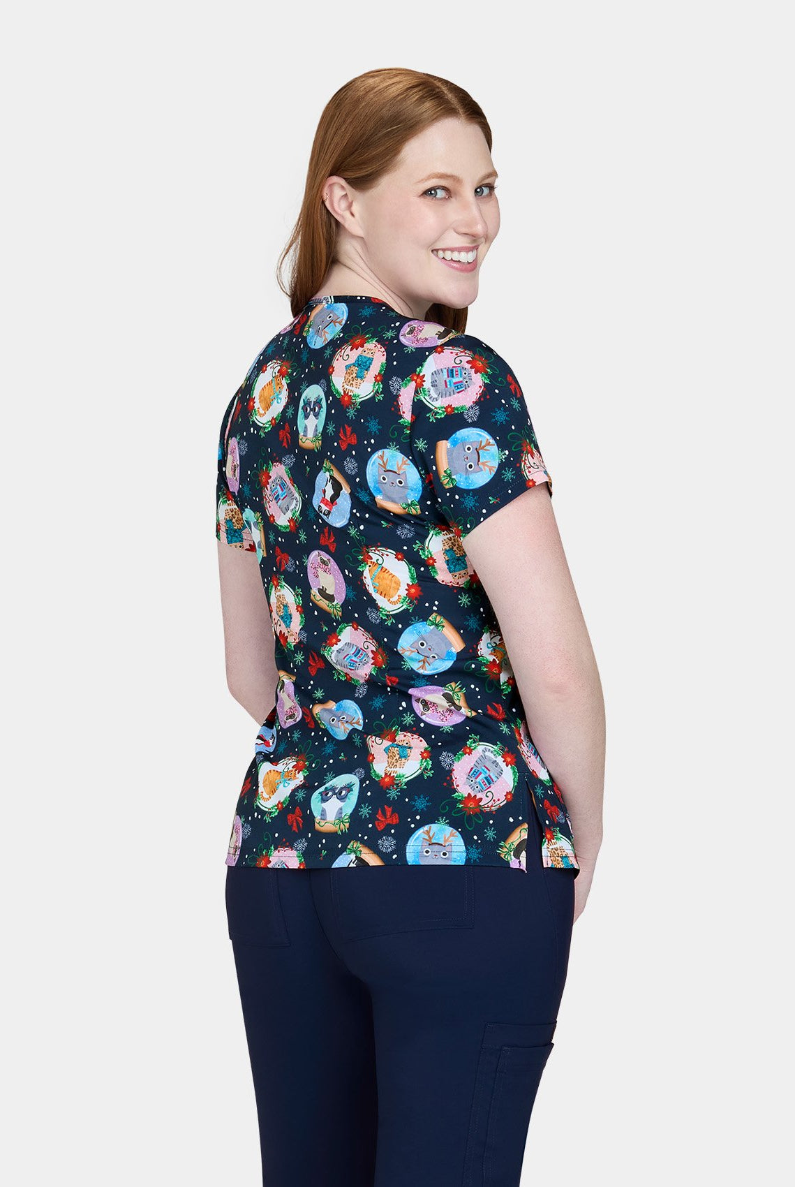 Back view of Koi Basics Leslie scrub top ā Holiday Cats print